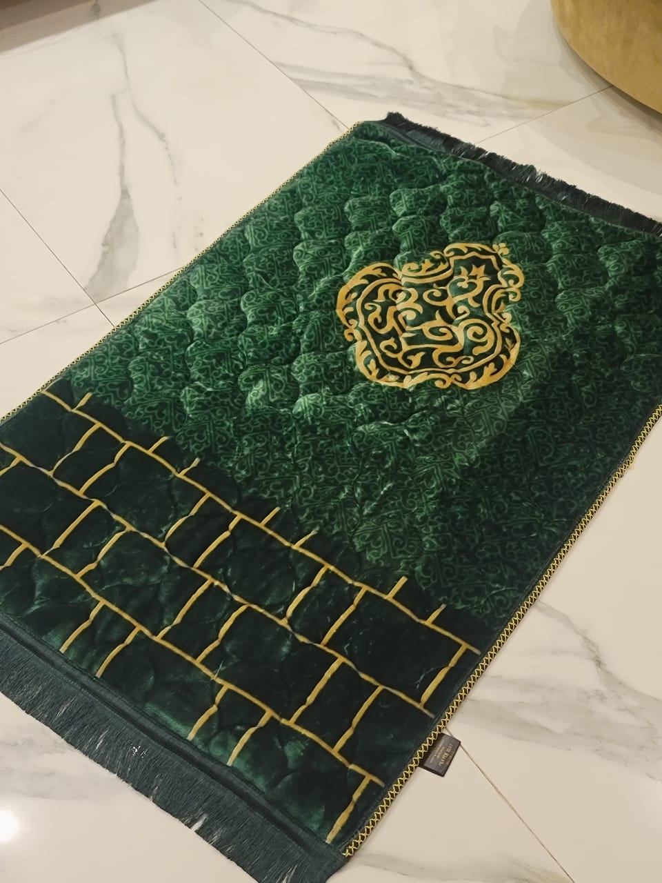 A Green jaynamaz - prayer Mate with a motive design online available at Idara-e-Islamiat, displayed for daily Muslim prayers. 