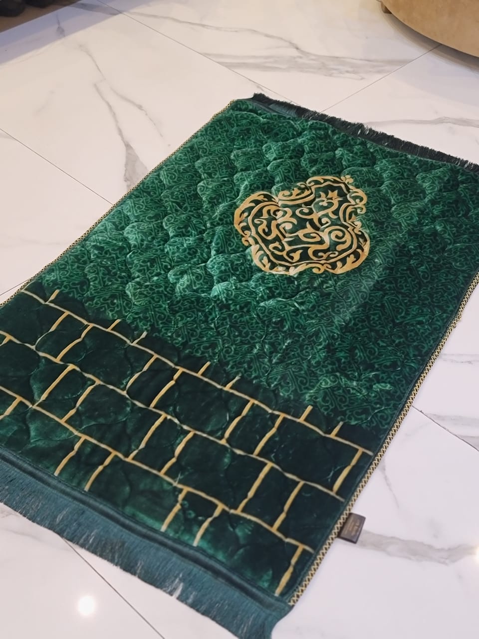 A Green jaynamaz - prayer Mate with a motive design online available at Idara-e-Islamiat, displayed for daily Muslim prayers. 