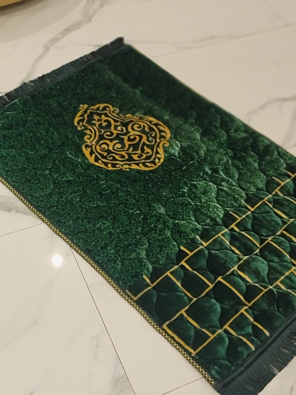 A Green jaynamaz - prayer Mate with a motive design online available at Idara-e-Islamiat, displayed for daily Muslim prayers. 