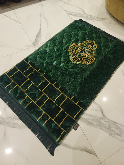 A Green jaynamaz - prayer Mate with a motive design online available at Idara-e-Islamiat, displayed for daily Muslim prayers. 