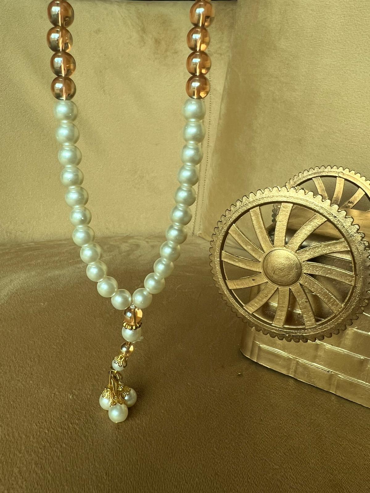 A premium Tasbeeh with white pearl-like beads and gold-tone accents, 100 beads and Quality materials.